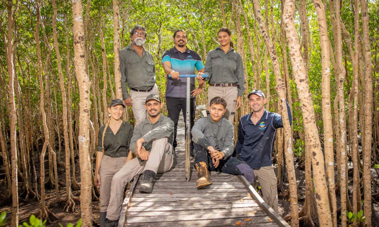 The team on a boardwalk through the mangroves. Back row: George Singleton, Gavin Singleton, Ashlyn Skeene. Front row: Lucy Friend, Tarquin Singelton, Mathew Skeene, Peter Macreadie. Credit: Through The Looking Glass Studio.