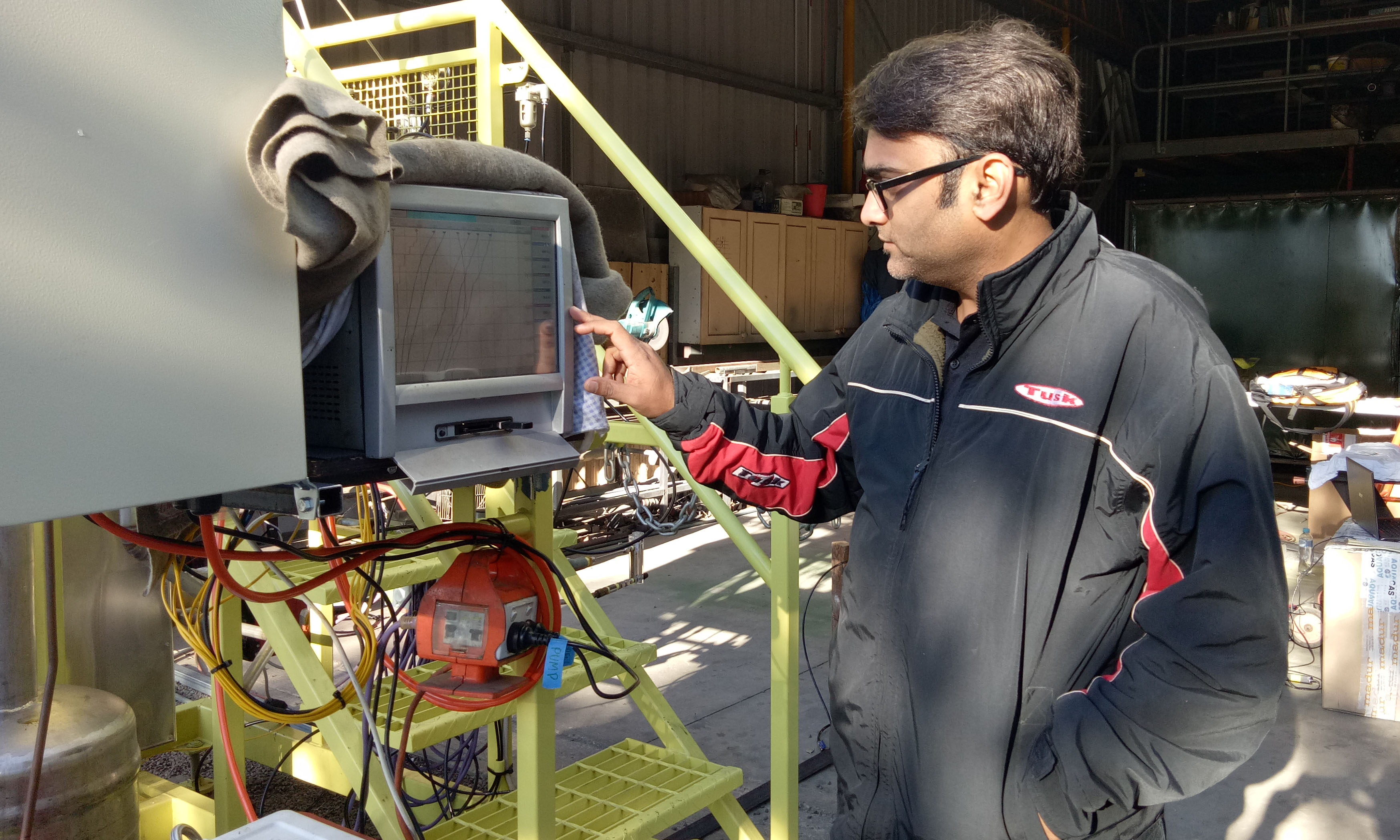 Lead researcher Associate Professor Kalpit Shah, with the novel reactor developed and patented by RMIT University.