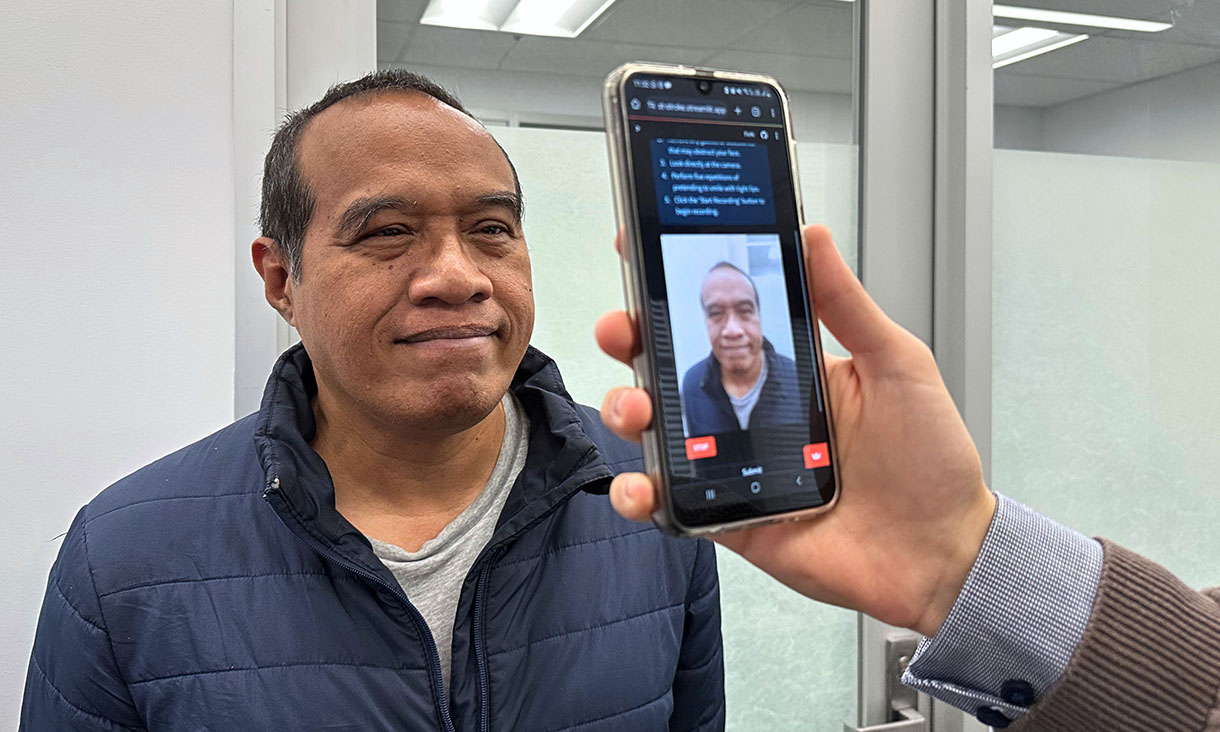 PhD scholar Guilherme Camargo de Oliveira demonstrates the face screening tool with Visiting Associate Professor Nemuel Daniel Pah (left) from RMIT University. Credit: Seamus Daniel, RMIT University