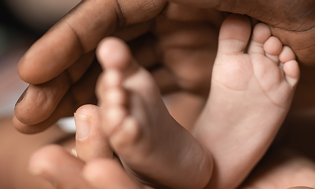 Hands holding a baby's feet