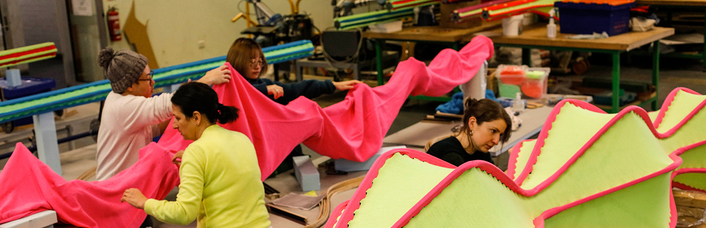 People working with coloured textiles