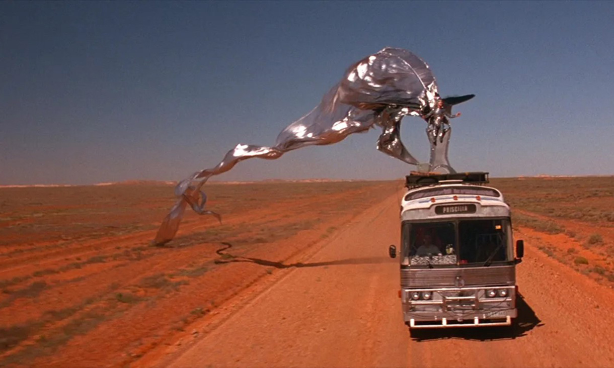 A bus on a dirt road in the desert