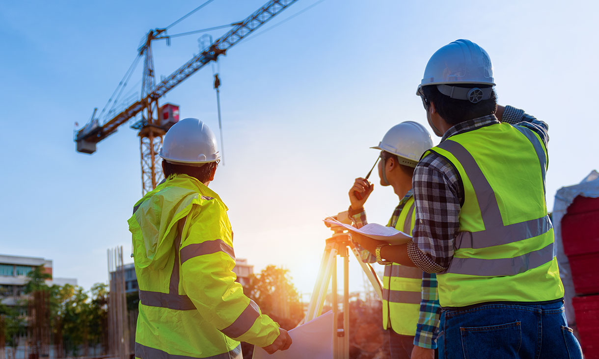 Construction engineers discussion with architects at construction site or building site of highrise building with Surveying for making contour plans is a graphical representation of the lay in land.