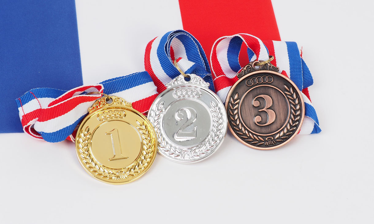 Three medal in gold and silver and bronze and french flag on white background.
