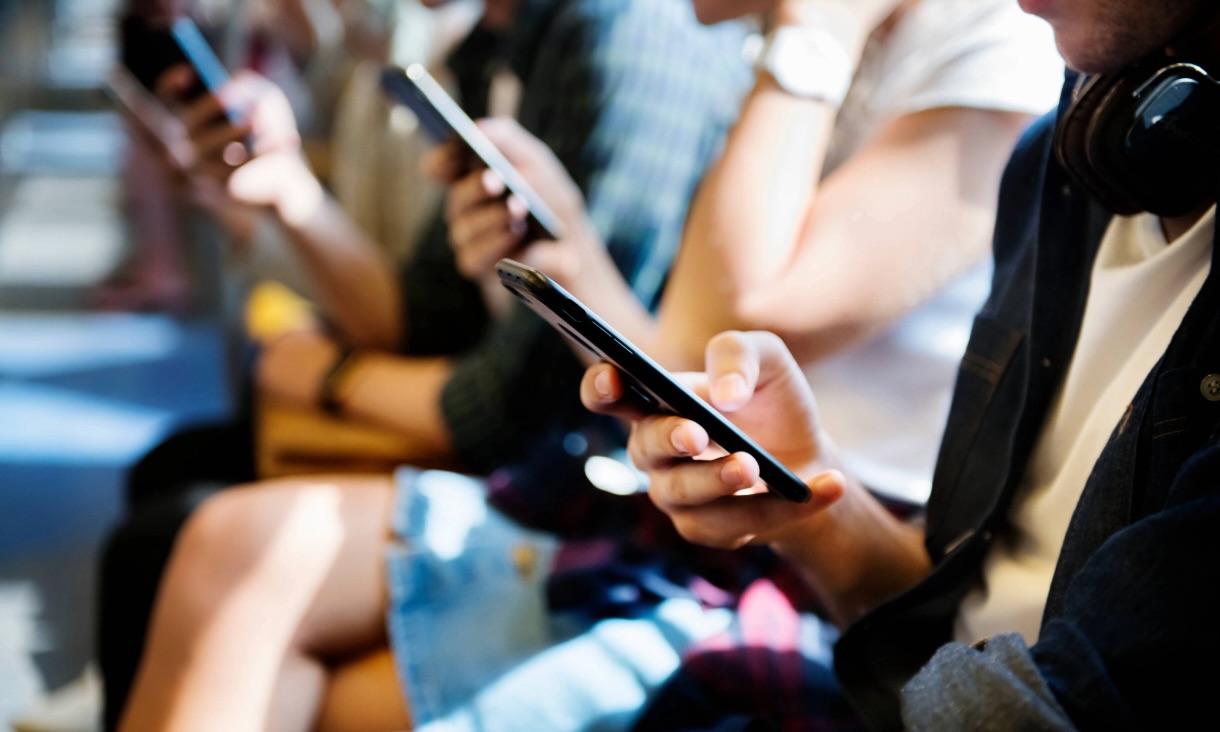 Close up of young people using smartphones