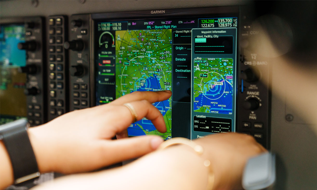 three pilots plotting a course on a map