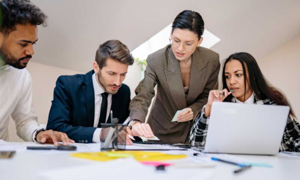 Office workers in discussion with post it notes