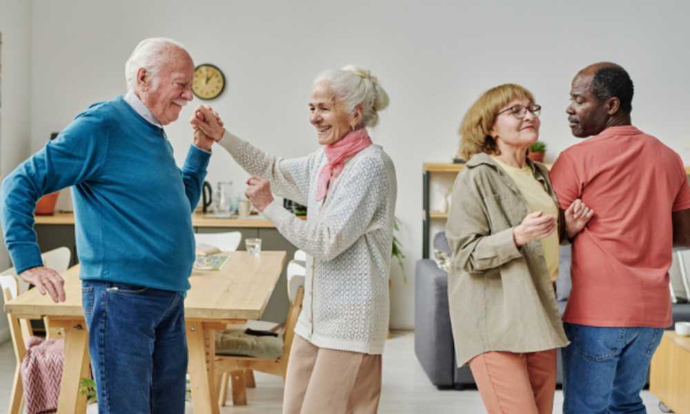 Four elderly people dancing