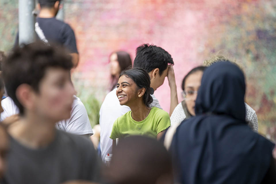 A student smiling in a crowd