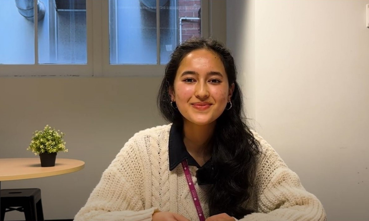 Seated student smiling at camera