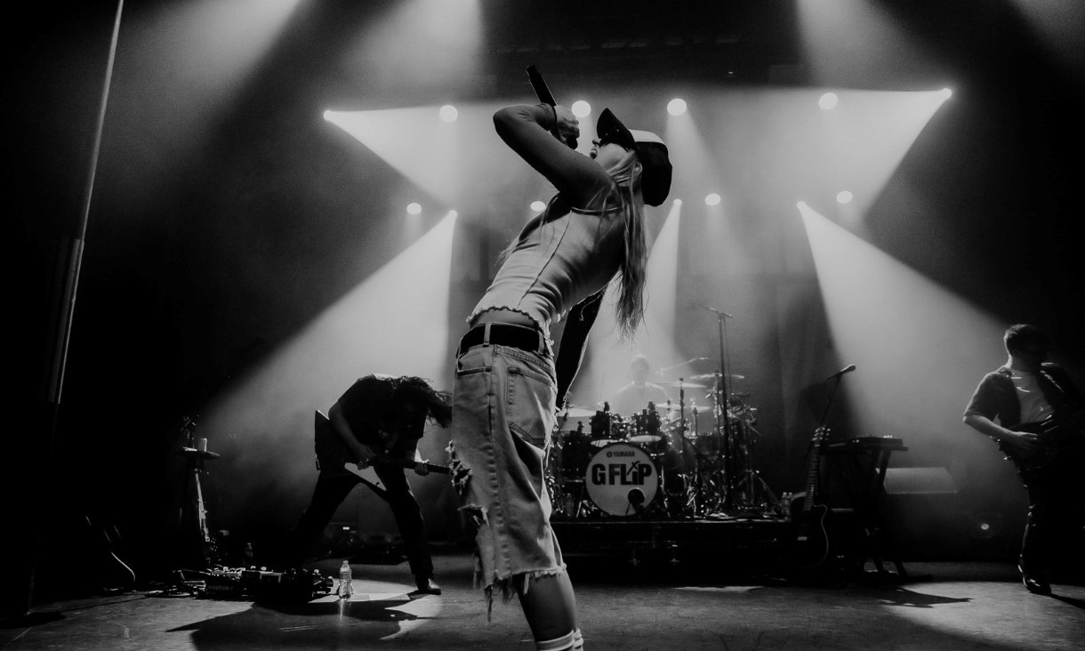 Black and white image of woman singing on stage