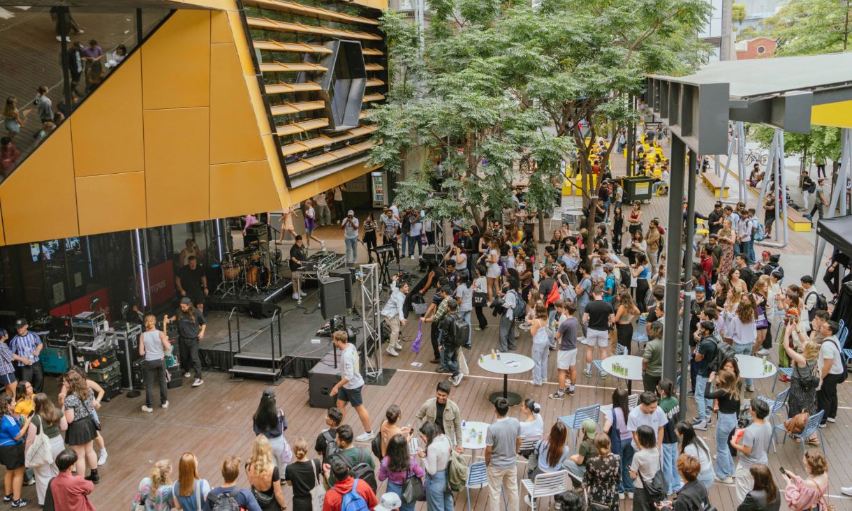 Arial view of people dancing in front of a stage.