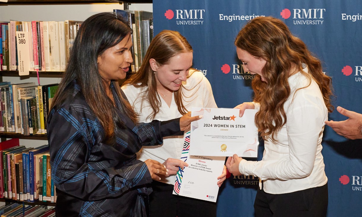 Grace (right) and teammate Charlotte (middle) receiving the Jetstar Women in STEM Award.