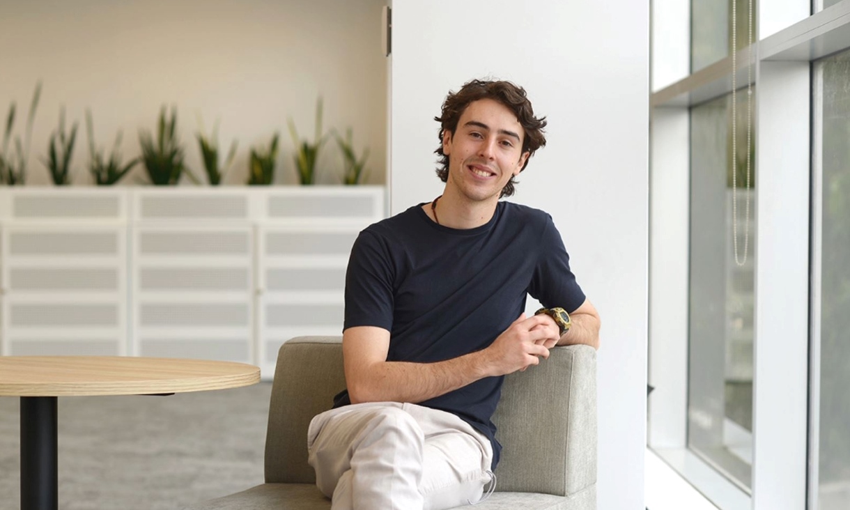 Person sits on chair for a portrait photo.