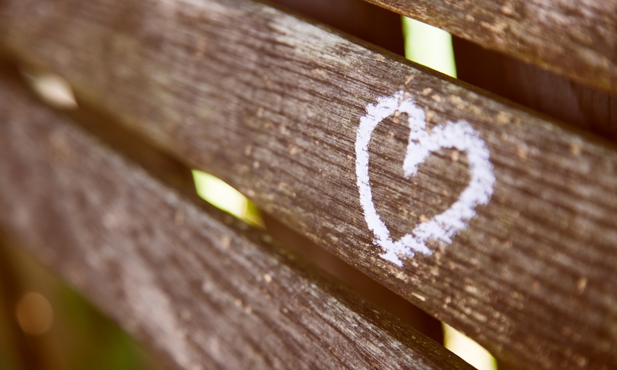 Wooden fence with white love heart