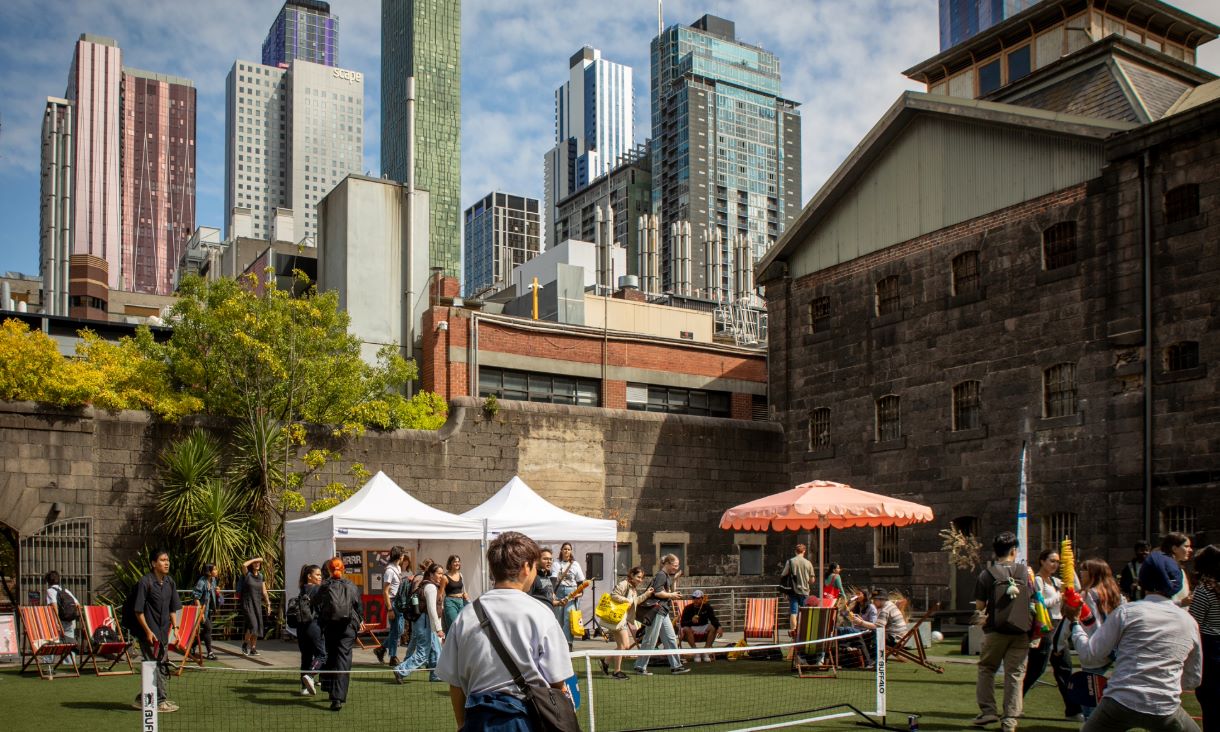 People mingle on a courtyard.