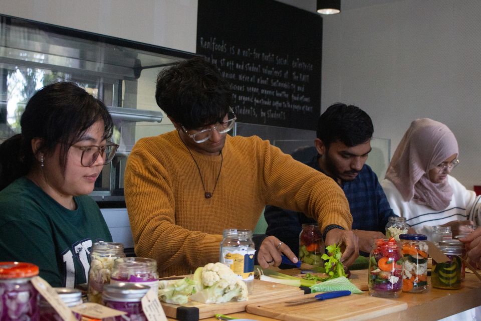 Students chopping vegetables.