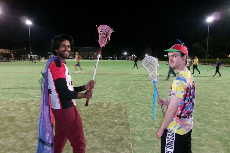 Student in pride rainbow socks playing hockey