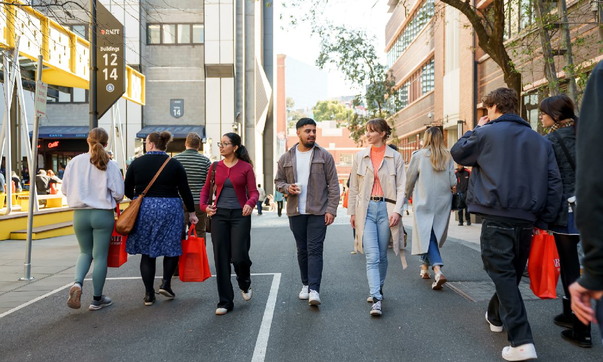 Group of students walking outdoors on bowen street, Melbourne city campus