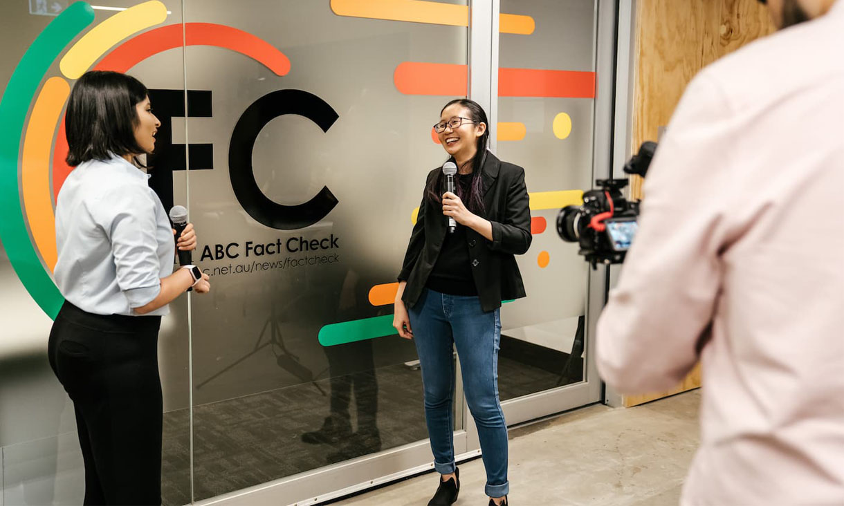 An RMIT journalism student conducts an interview outside ABC Fact Check.