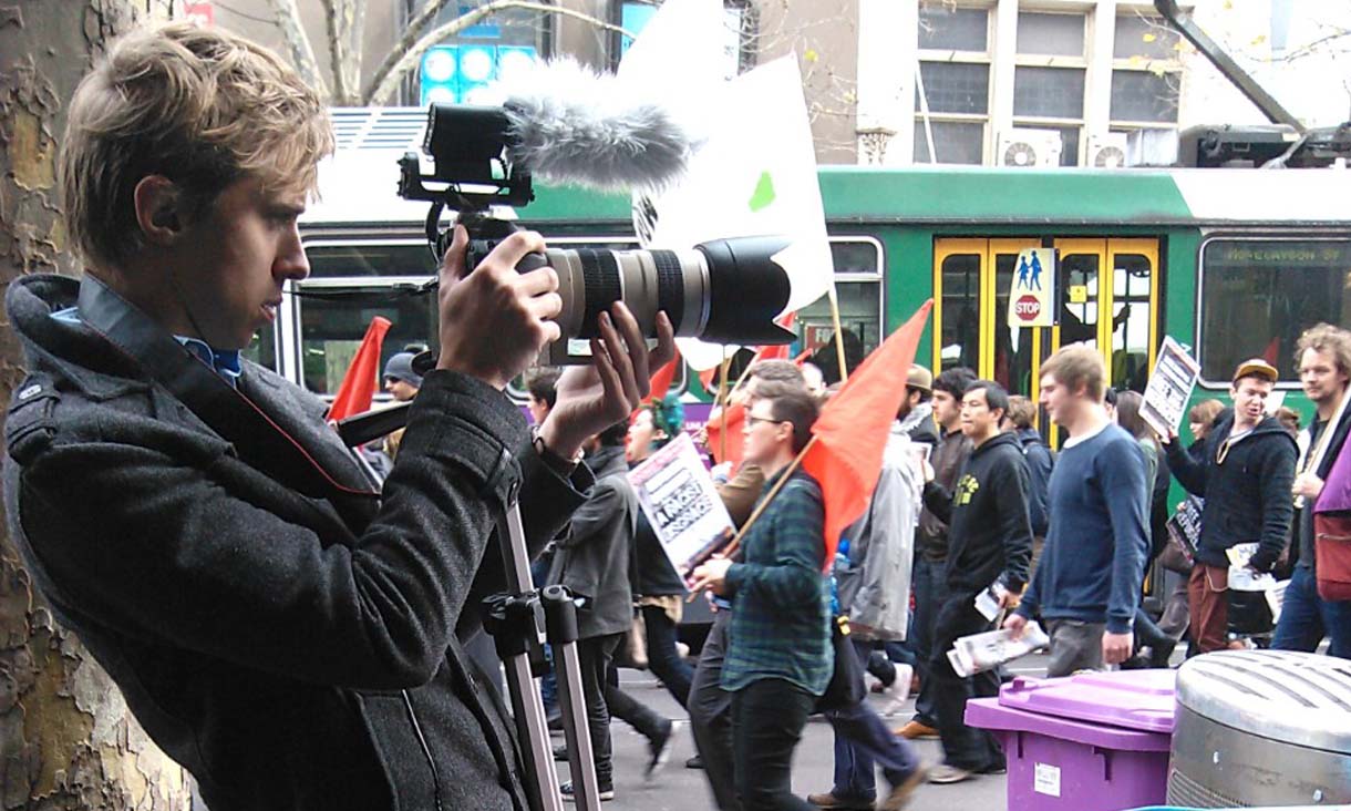 Soren Frederiksen takes a photo of a protest in the Melbourne CBD.