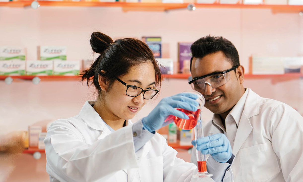 Two RMIT pharmacy students create compound medication in a practice pharmacy.