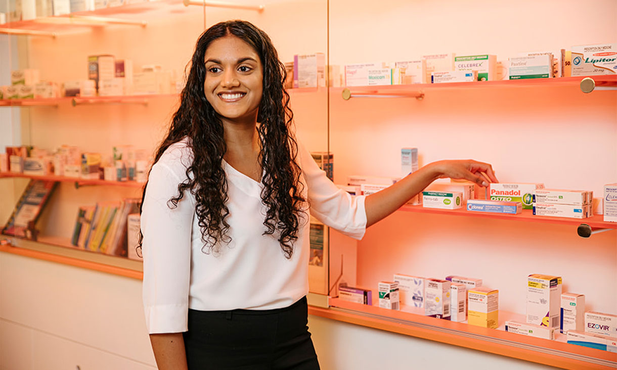 Pharmacy student dispenses medication in practice pharmacy.
