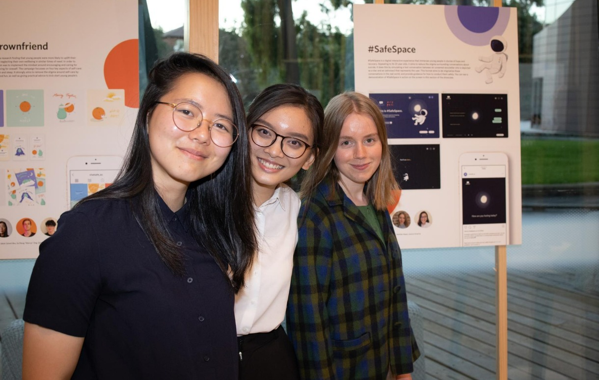 RMIT Communication design students Linsy Angwyn, Joanne Pangkey and Matilda Heeps in front of their work at the Melbourne Design Week exhibition of Ethical Design in Suicide Prevention