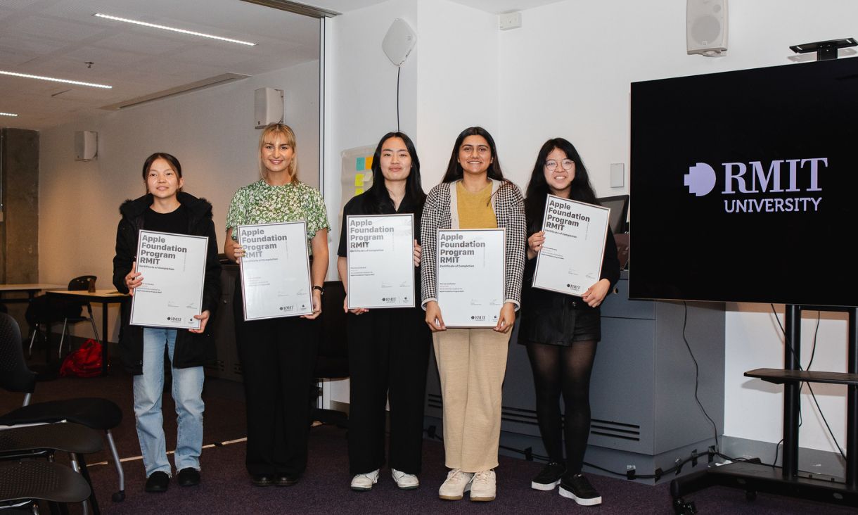 Group of five program participants holding up certificates