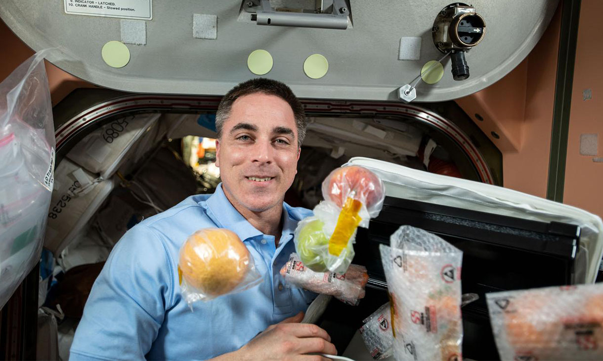 NASA astronaut Chris Cassidy unpacks fresh fruit and other food items shipped aboard the Northrop Grumman Cygnus space freighter to the International Space Station. Credit: NASA