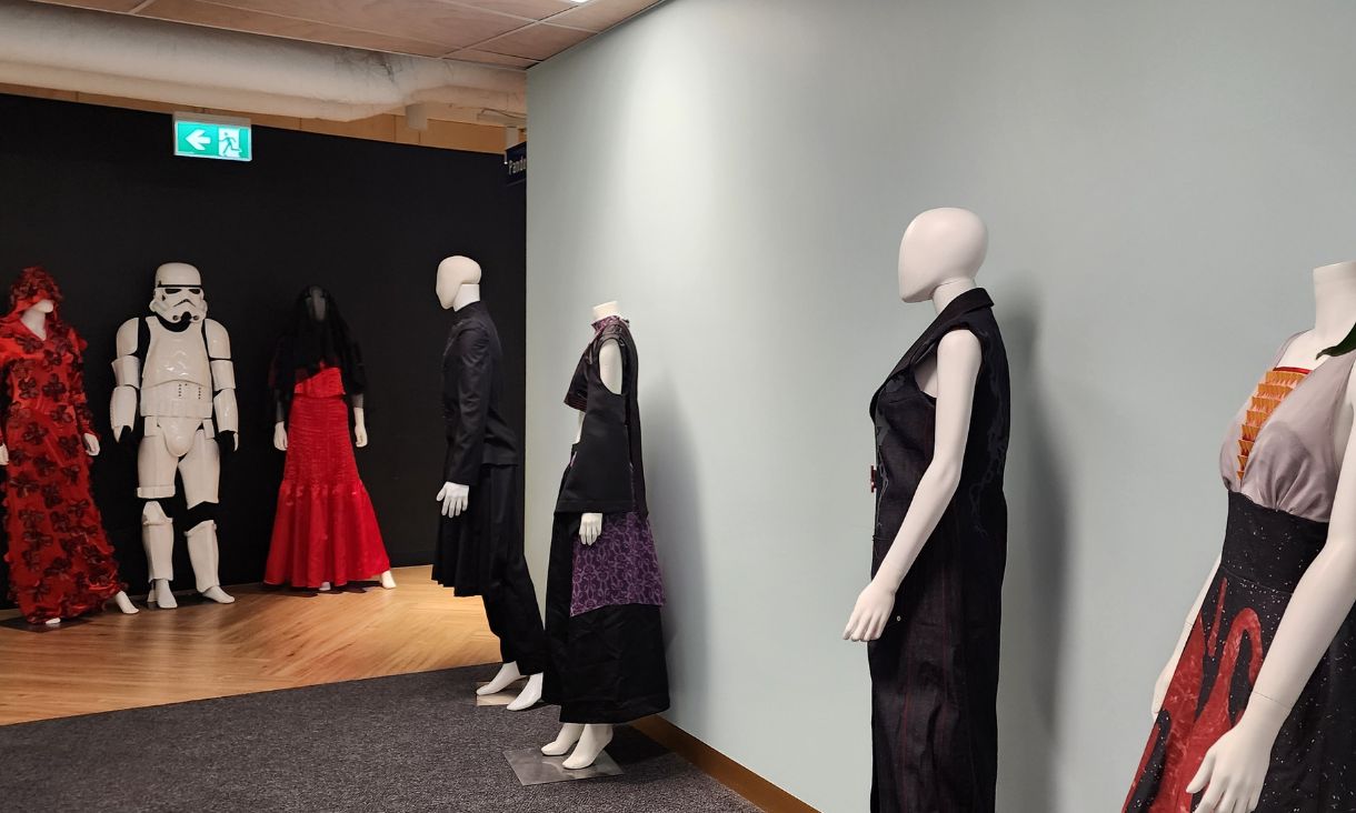 Mannequins wearing student-made garments.