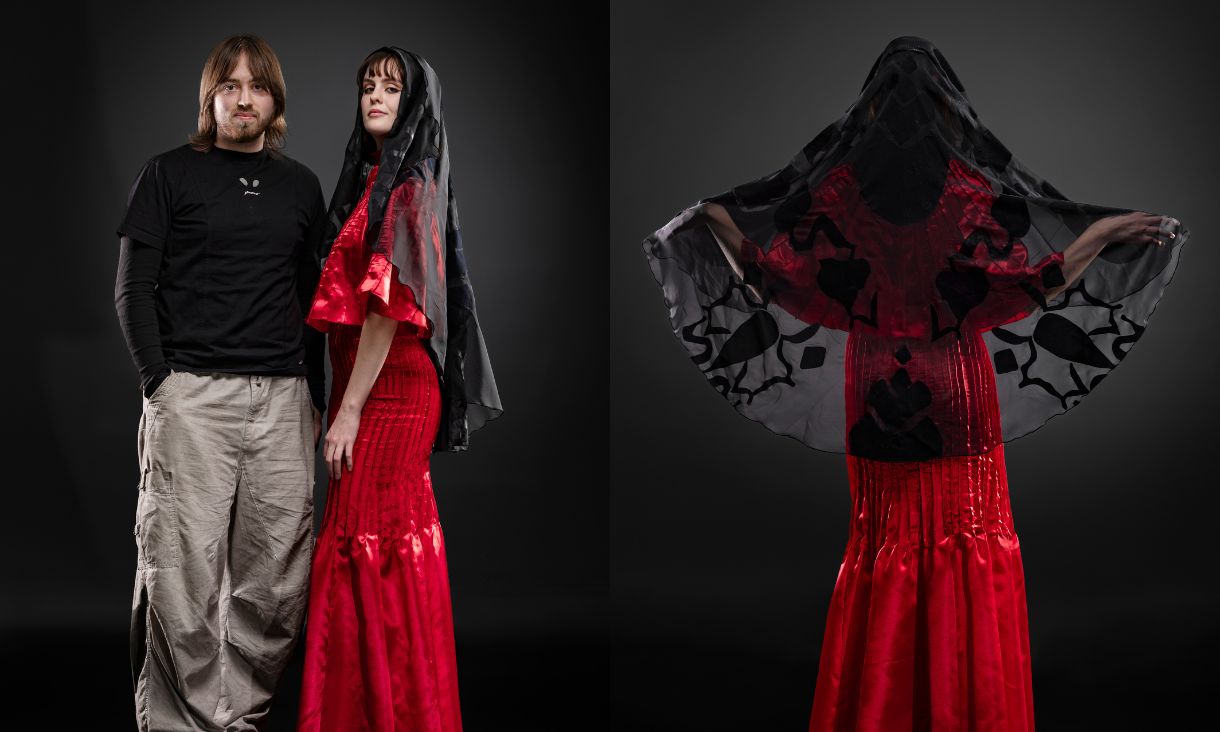 Austin next to a model who is wearing a long red dress and black sheer veil