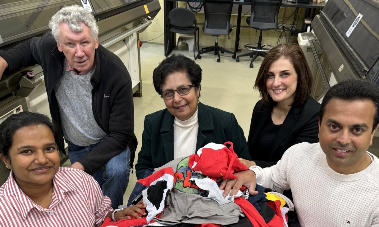 The research team with a pile of discarded clothes that could be used in their concrete. Credit: Will Wright, RMIT University