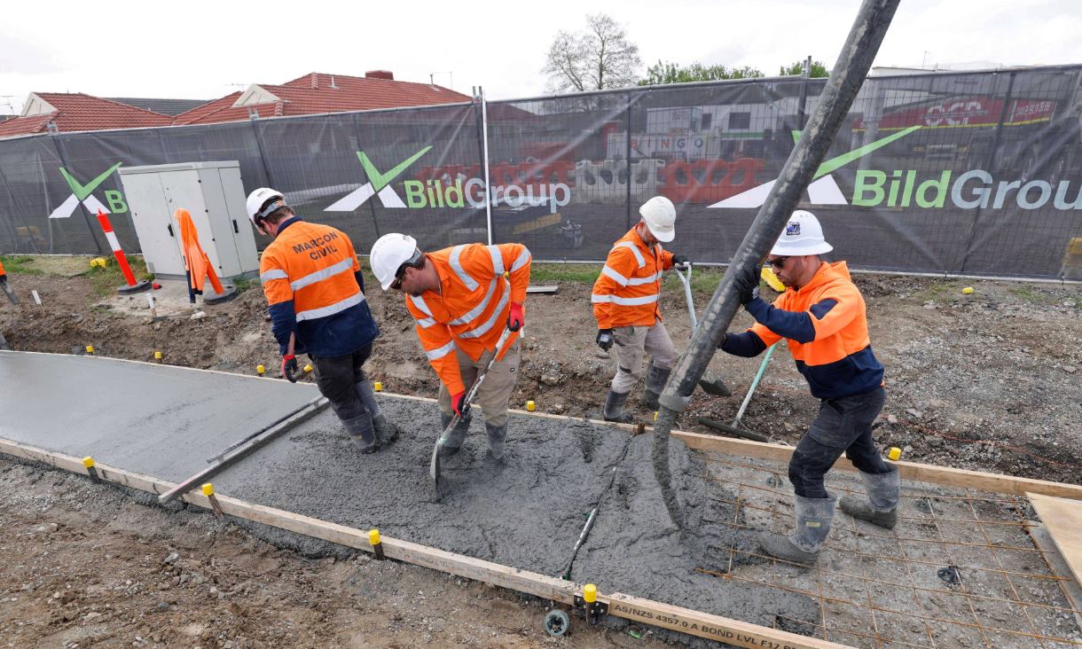 Workers laying coffee concrete in a new footpath along McGregor Road in Pakenham. Credit: Pete Glenane, HiVis Pictures