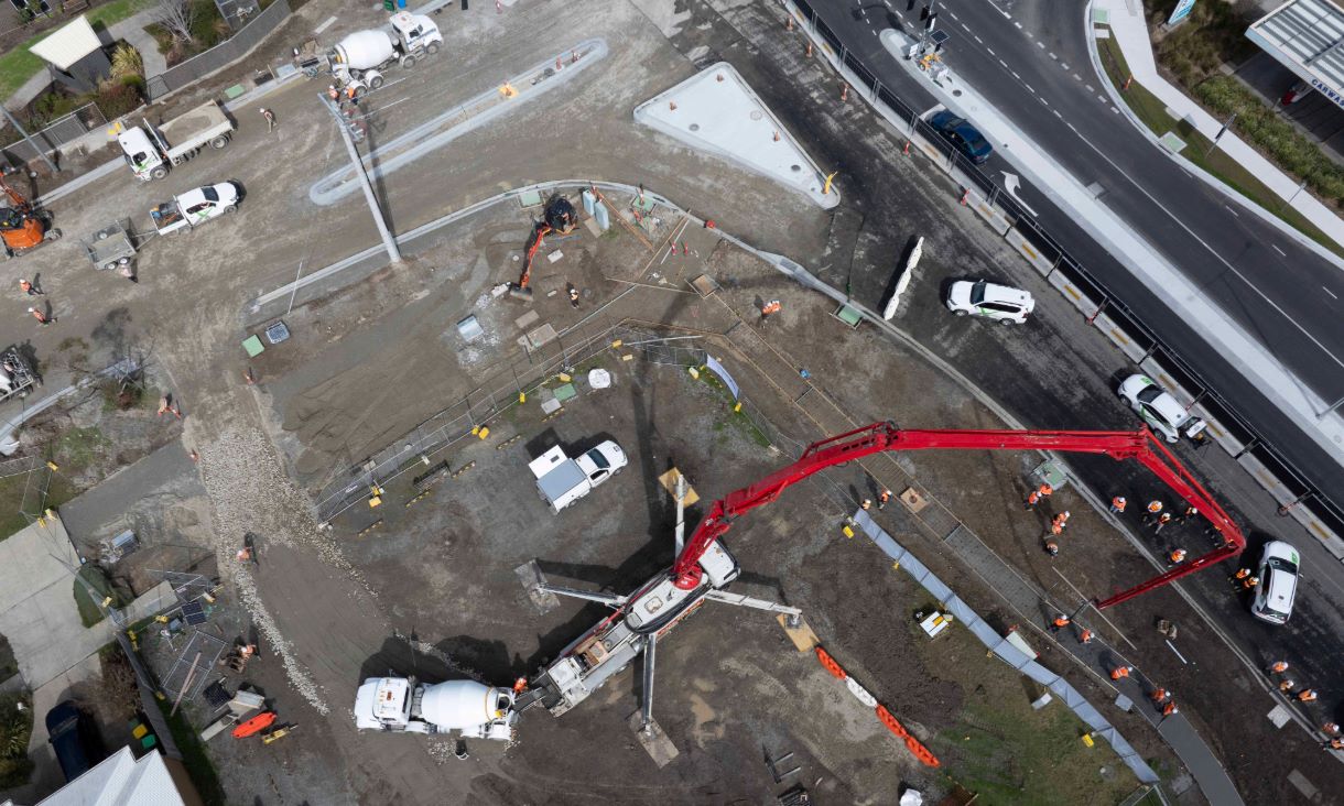 Bird's eye view of the coffee concrete footpath being laid along a busy road in Pakenham. Credit: Pete Glenane, HiVis Pictures