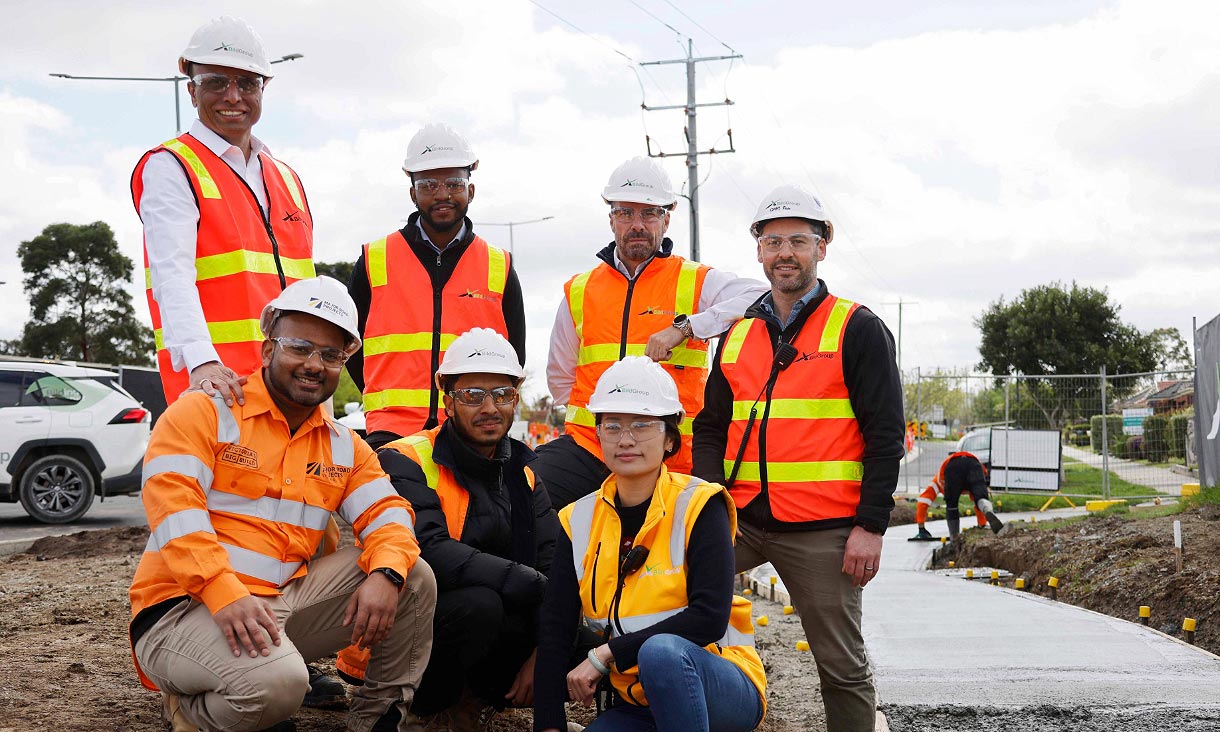 Dr Rajeev Roychand (back left) with BildGroup employees who are RMIT alumni including the CEO Stephen Hill (second from right, at the back) at the site of the Pakenham Roads Upgrade. Credit: Pete Glenane, HiVis Pictures