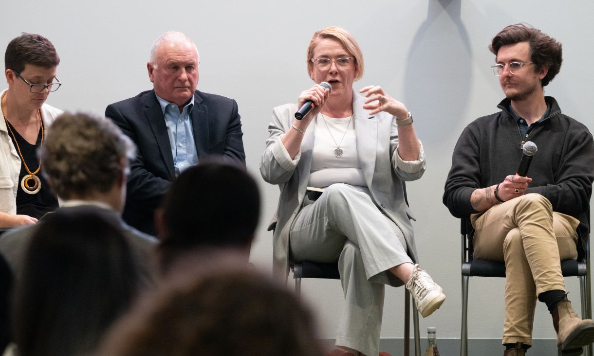 Panel members engaged in conversation.