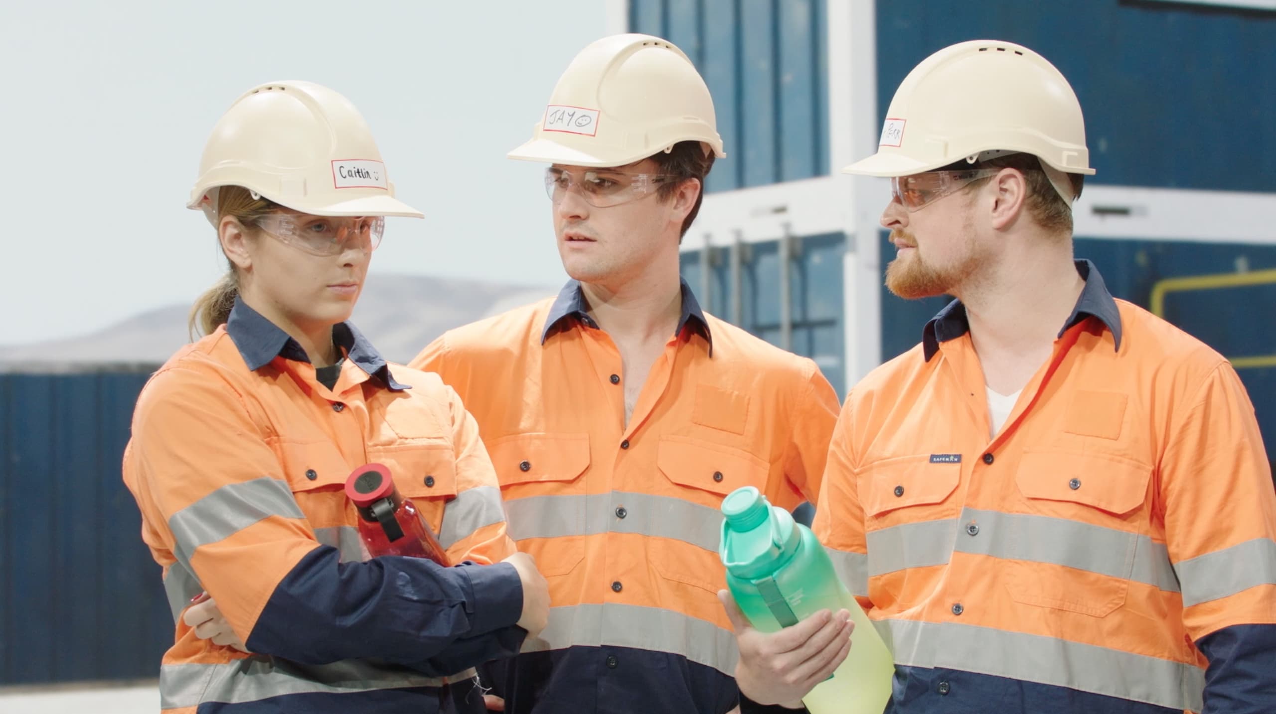 Three construction workers in discussion